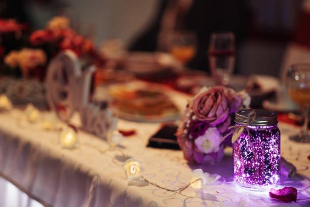 Beautiful table setting with crockery and flowers for a party, wedding reception or other festive event. Glassware and cutlery for catered event dinner.
