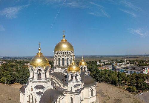 Golden domes of the Ascension Cathedral on Yermak Square in Novocherkassk in southern Russia.\nLuxurious aerial view on a sunny summer day mid-August.