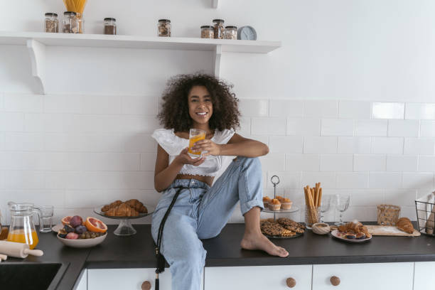 istock Easy-going girl having orange juice for breakfast 1179008424
