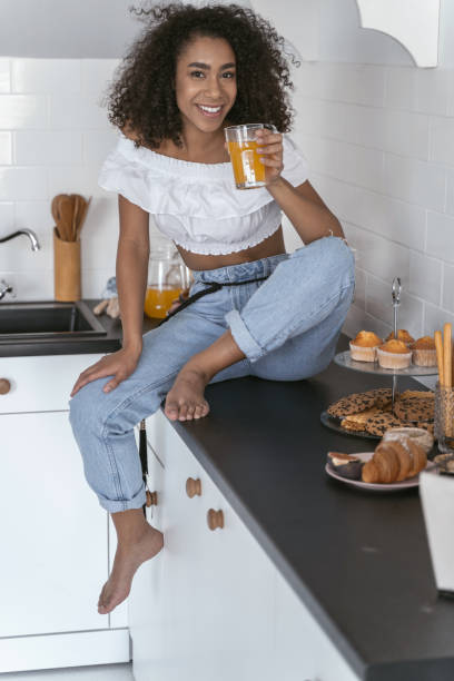 istock Pretty woman drinking juice in her kitchen 1179008444