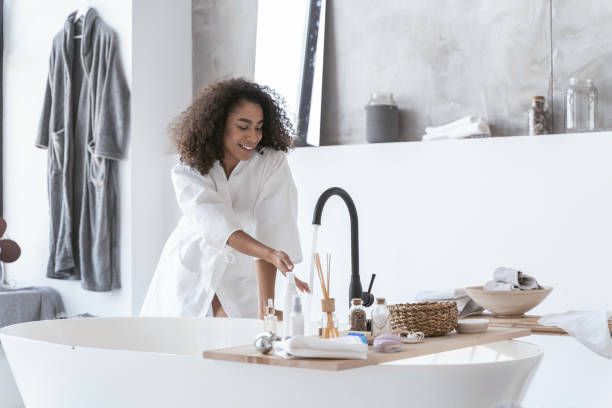 istock Woman checking on the running water temperature 1179008507