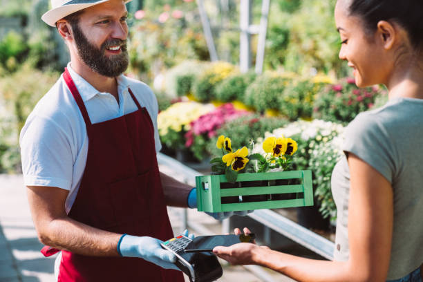 istock Customer in the garden center paying contactless 1179009242