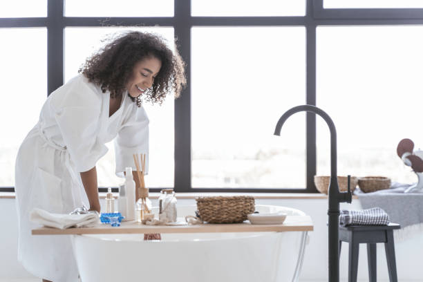 istock Happy woman checking on the water temperature 1179009401