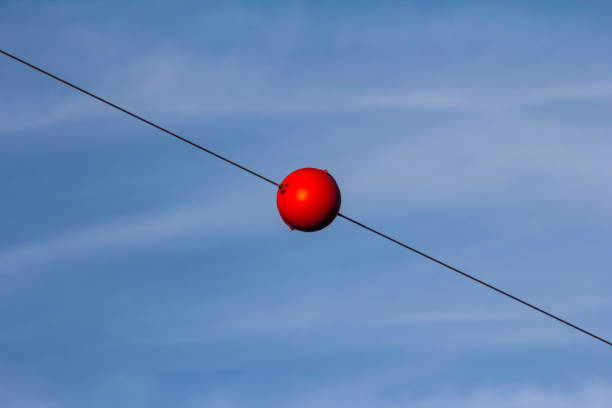 red ball on blue sky stock photo