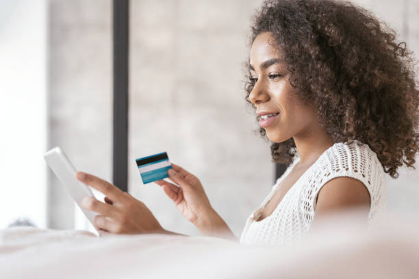 istock Pleased curly haired girl looking at her tablet 1179010736