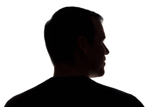 istock Portrait of a young man, back view - dark isolated silhouette 1179013424