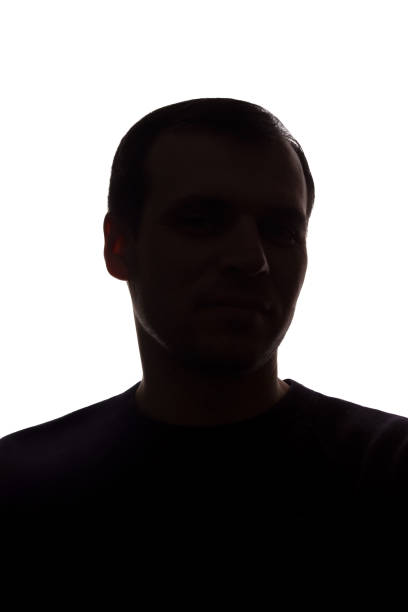 istock Portrait of a young man, front view - dark isolated silhouette 1179013592