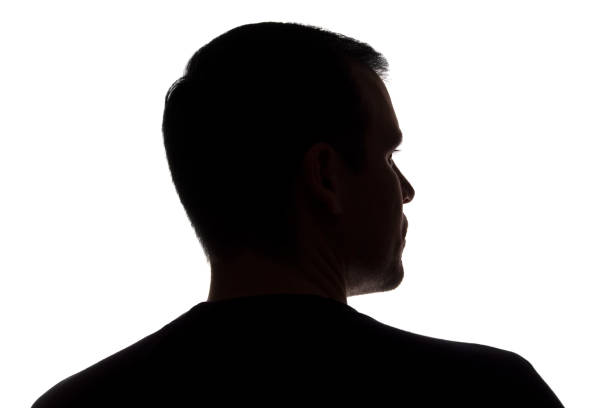 istock Portrait of a young man, back view - dark isolated silhouette 1179013709