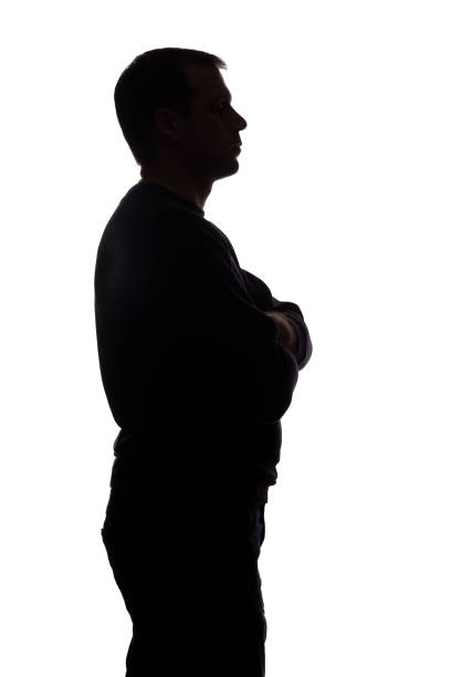 istock Portrait of a young man, side view - dark isolated silhouette 1179013735