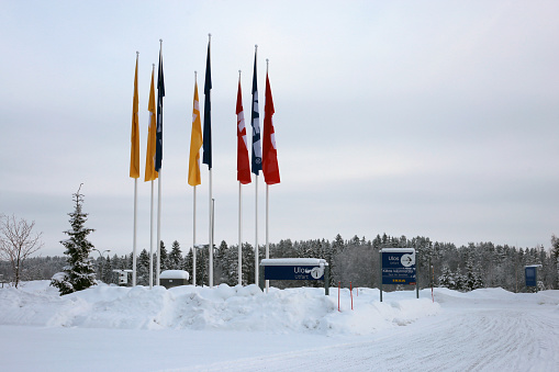 January 2019, Kuopio, Finland. Multiple colorful Ikea retail flags during a cold winter day. You can also see a lot of snow on the Ikea parking lot in front of the flags. Landscape image.