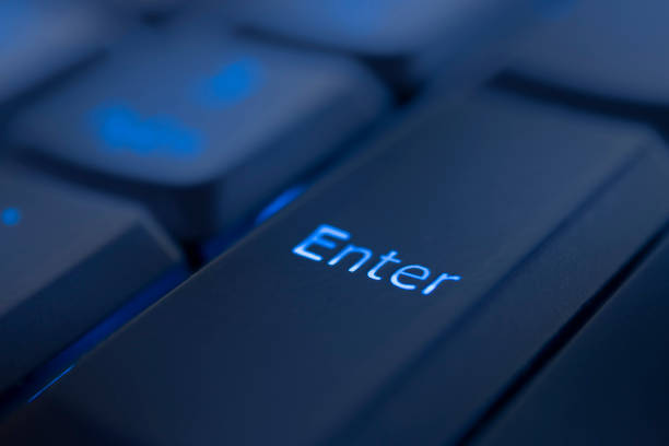 istock Enter key illuminated by blue LED light. Close-up of computer keyboard. 1179016488