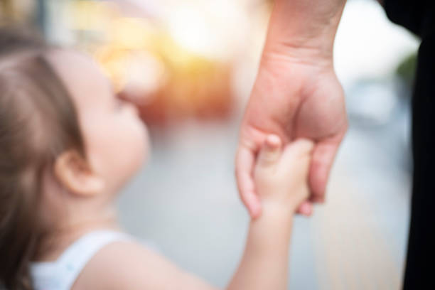istock Mother and daughter holding hands 1179020238