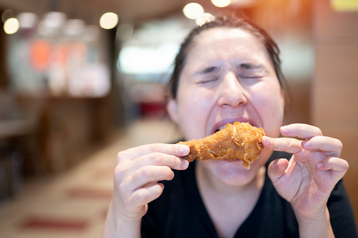 Young woman with fried chicken