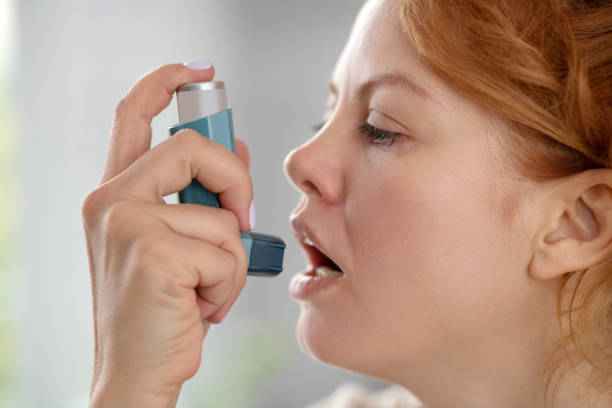 istock Close up of young woman using inhalator while having attack 1179020465