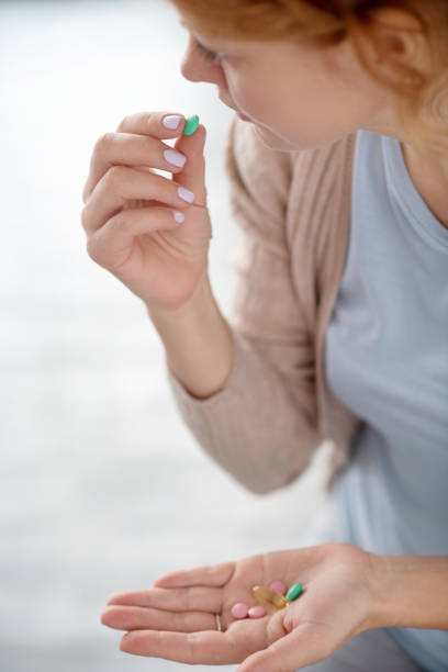 istock Sick woman drinking pills after catching cold 1179020504