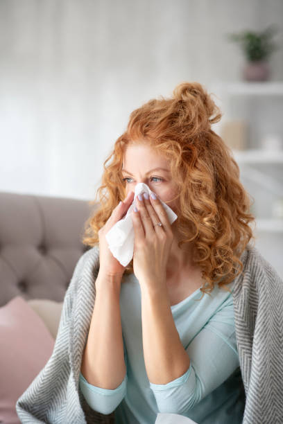 istock Woman having sneeze while suffering from epidemic 1179020846
