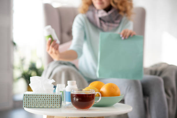 istock Orange and tea standing on the table while woman having flu 1179020904