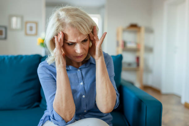 istock Senior Woman with Headache 1179022358
