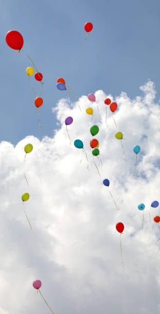 istock colored balloons fly into the sky with clouds during the party 1179023436