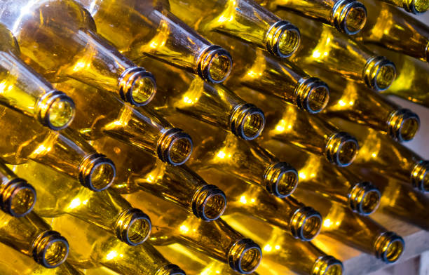 istock glass beer bottles lie in rows, necks on camera, shallow depth of sharp 1179023924