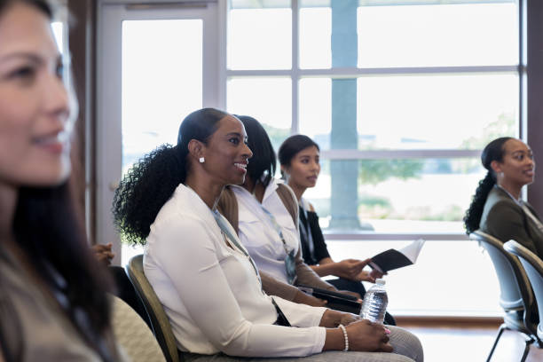 istock Diverse women enjoy presentation by conference speaker 1179025348
