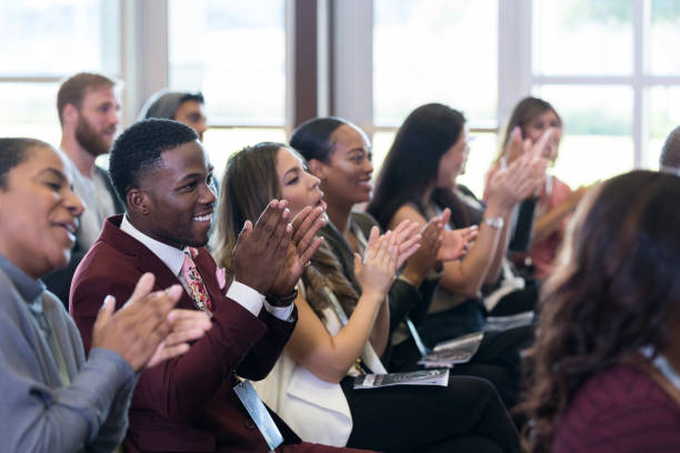 istock Diverse conference audience claps and smiles after lecture 1179025379