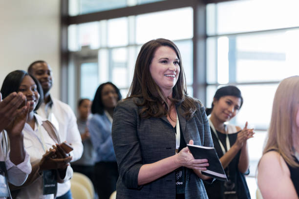 istock Diverse conference audience stands and applauds unseen speaker 1179025393