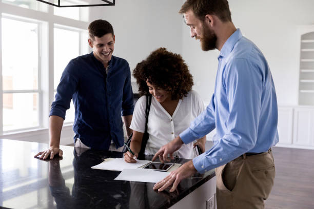 istock Young woman signs documents in new home 1179026127