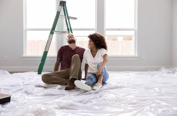 istock Happy couple relax while painting a room 1179026170