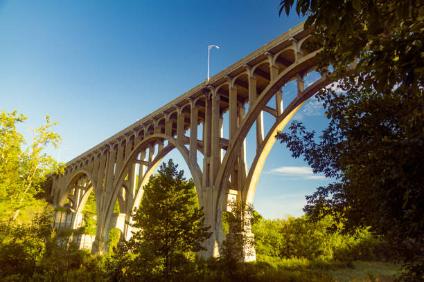 Arch bridge spanning a river in Cuyahoga Valley National Park Arch bridge spanning a river in Cuyahoga Valley National Park cuyahoga river photos stock pictures, royalty-free photos & images