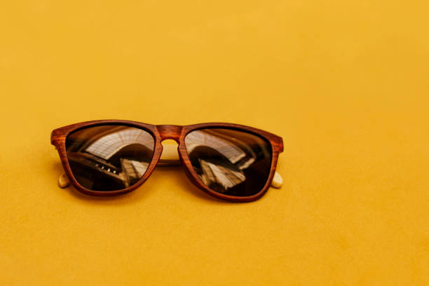 istock Sunglasses on yellow background. 1179033715