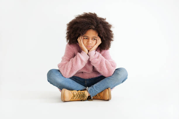 Cute girl in casual clothing is feeling sad Cute girl in casual clothing is feeling sad. Portrait against white background baby girls stock pictures, royalty-free photos & images