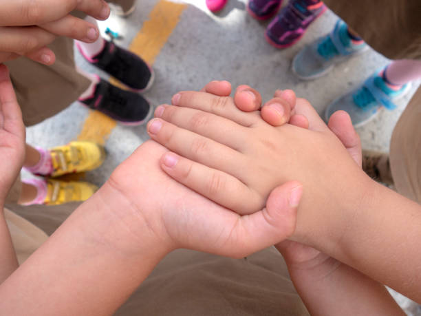 istock little children holding hands - they play games 1179043867