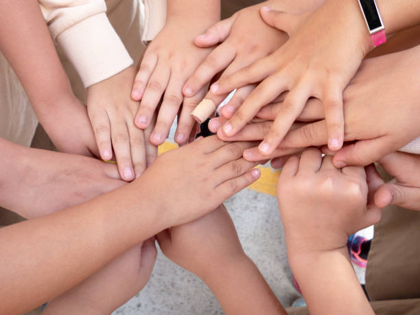 istock little children holding hands - they play games 1179043948