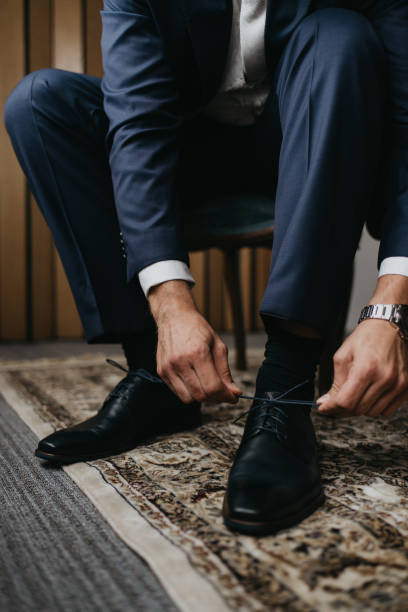 istock Groom dressing up with classic elegant shoes. 1179045816