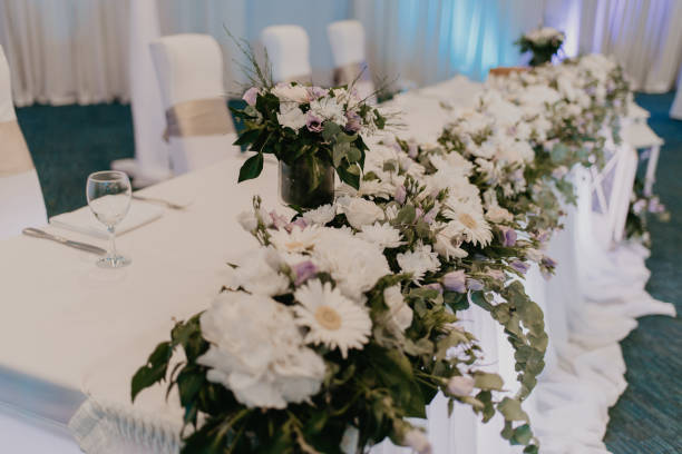 istock Wedding table with a lot of white flowers. 1179046452