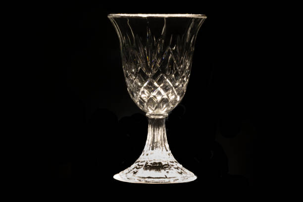 istock illuminated Cut crystal glass with black background,play of lights and shadow 1179046567