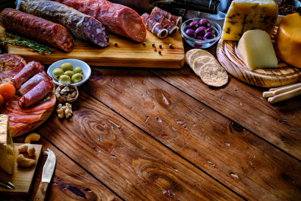 istock Tapas of cured ham and cheese delicious appetizer on rustic wood table with copy space 1179047117