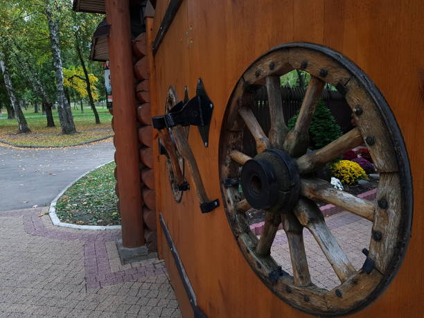 istock Decorative fence and gate with wooden wheel inserts and ax handles. 1179048053