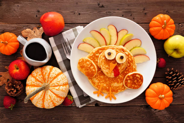 istock Thanksgiving breakfast table scene with turkey pancakes, top view against rustic wood 1179048120