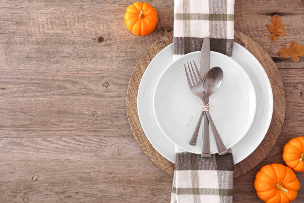 istock Thanksgiving or fall harvest table setting, top view, side border against a wood background 1179049198