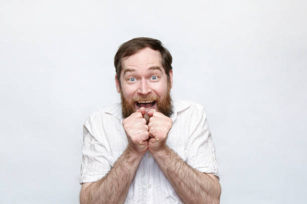 istock Smiling man clapping hands in excitement over gray background 1179049245