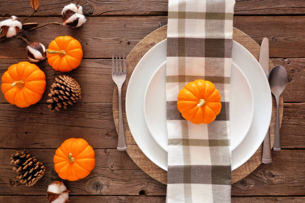istock Autumn harvest or thanksgiving dinner table setting, top view on a rustic wood background 1179050030