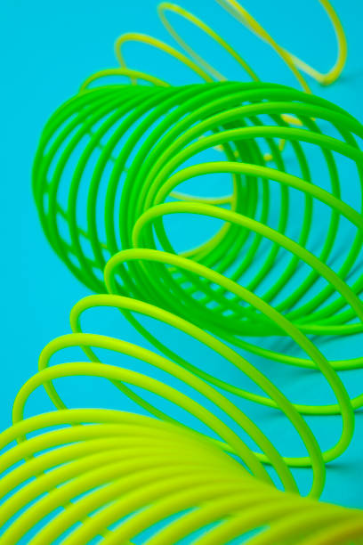 istock Toy plastic rainbow slink on blue 1179050197