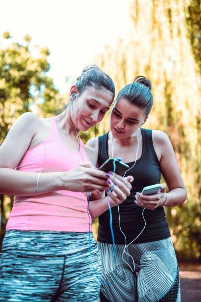 istock Two Females Exchanging Music Playlists 1179052352