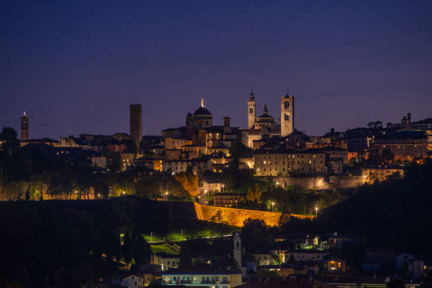Bergamo upper town of Bergamo illuminated at night bergamo stock pictures, royalty-free photos & images