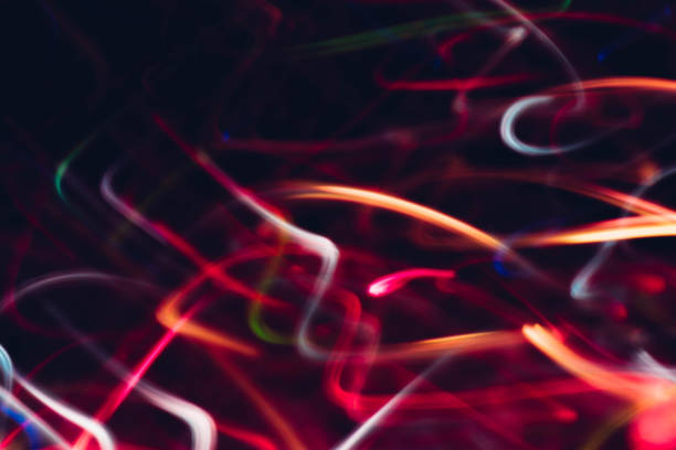 istock neon magenta purple lights glowing curvy lines 1179064429