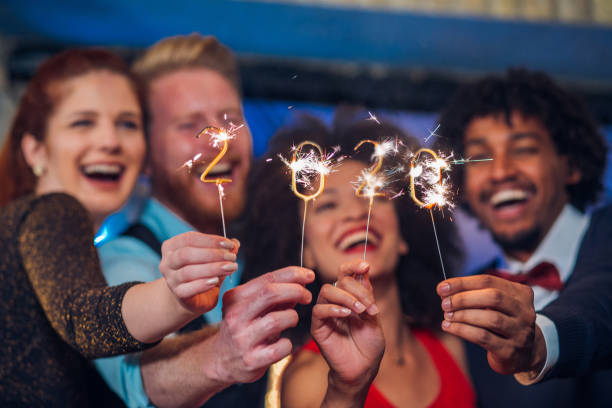 istock Smiling people holding sparklers 1179065744