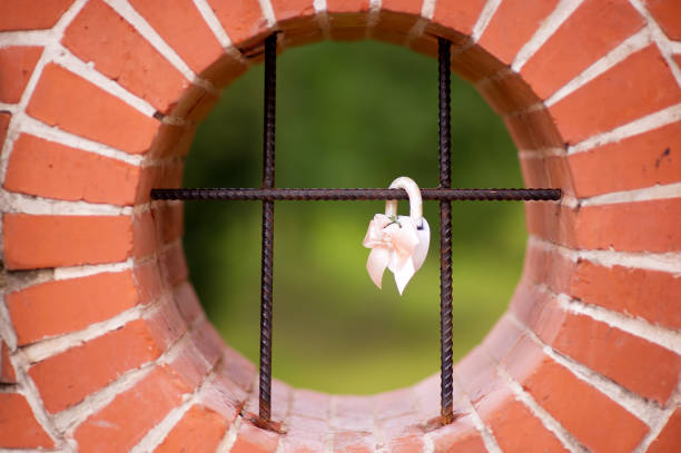 istock a white decorated wedding castle hanging on a black grate in a stone wall opening 1179065763