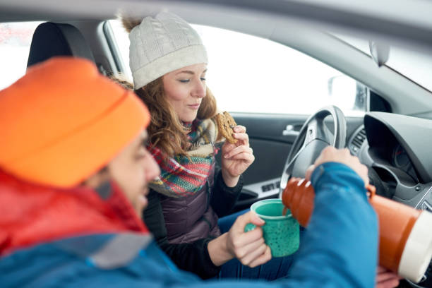 istock Smiling diverse couple holding Christmas presents while walking through a winter forest 1179065917